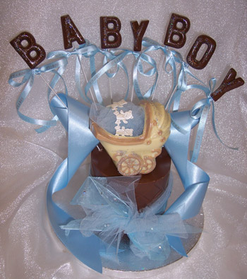 chocolate baby pram theme on single chocolate tier, decorated with ribbon