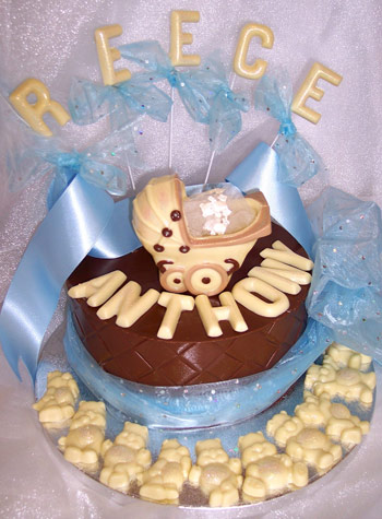 chocolate baby pram theme on single chocolate tier, decorated with ribbon