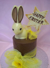 a picture of white chocolate Easter bunny on a milk chocolate tier