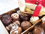 Hand-made chocolate truffles, gift wrapped in a gold box tied with ribbon