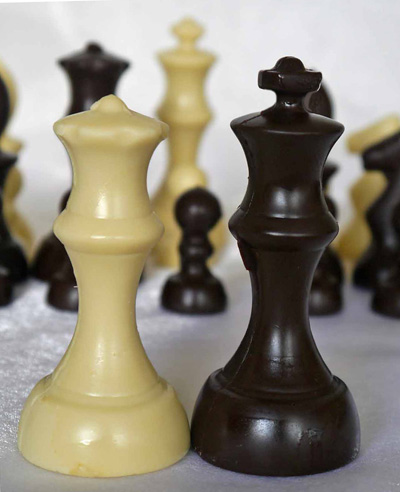 a picture of chocolate chess set decorated with white, and dark, chocolate