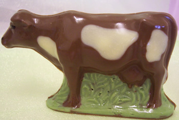 a picture of a milk chocolate cow decorated with white and coloured chocolate
