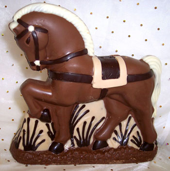 a picture of a milk chocolate horse decorated with white and dark chocolate