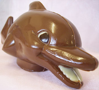 a picture of a milk chocolate dolphin decorated with white and dark chocolate