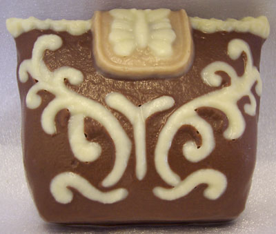 a picture of a milk chocolate embroidered bag, decorated with white chocolate