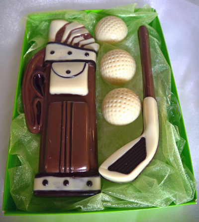 a picture of chocolate golf set decorated with white, dark, and milk chocolate