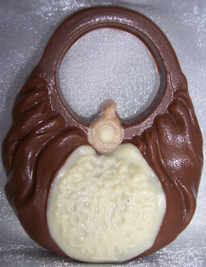 a picture of a milk chocolate handbag, decorated with white chocolate