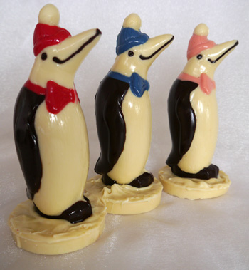 a picture of three white chocolate penguins