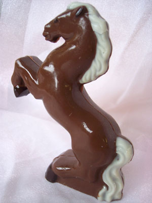 a picture of a milk chocolate rearing horse decorated with a white chocolate mane