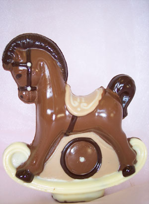 a picture of a milk chocolate rocking horse decorated with white