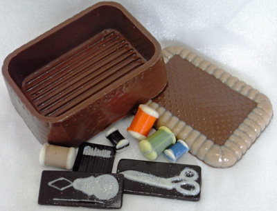 a picture of a milk chocolate sewing kit decorated with milk, white, dark, and coloured chocolate