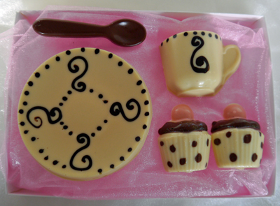 a picture of chocolate tea set with white, dark, milk chocolate, and cololured chocolate