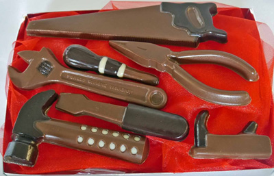 a picture of chocolate tool set decorated with white, and dark, chocolate