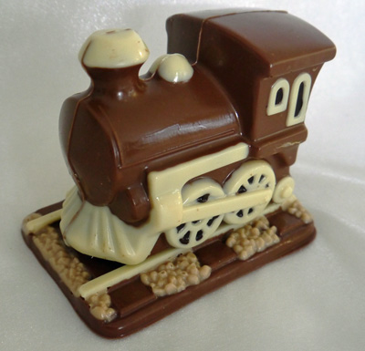 a picture of chocolate train engine decorated with white, milk and dark, chocolate