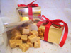 a picture of butter fusdge in a gold gift wrapped box