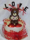a picture of a valentine bear car on chocolate tier