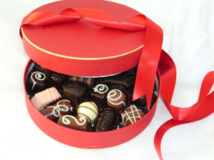 a picture of mixed truffles in round box