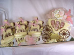 white chocolate carriage and horses decorated with a gold pink ribbon and butterfly