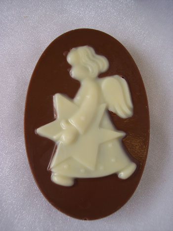 a picture of white chocolate angel on a milk chocolate base.