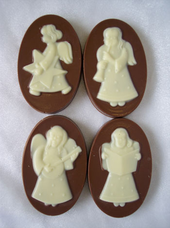 a picture of four white chocolate angels on milk chocolate bases.