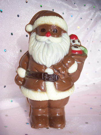 A milk chocolate Father Chirstmas decorated with white and coloured chocolate.