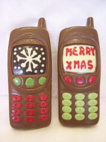 Two milk chocolate Chirstmas mobile phones decorated with coloured chocolate.  One display shows a snowflake, the other a 'Merry Xmas' message
