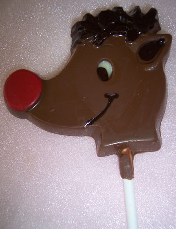 a picture of a small red nose raindeer on a stick decorated with milk dark and coloured chocolate.