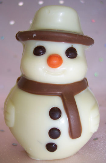a picture of a small white chocolate snowman decorated with milk and dark chocolate.