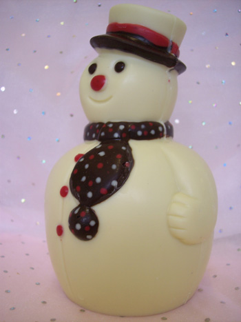 a picture of a white chocolate snowman decorated with coloured chocolate.